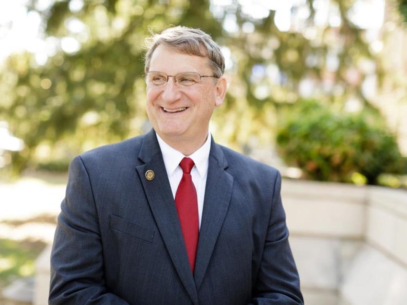 LRU President Dr Fred K Whitt smiling while looking off camera