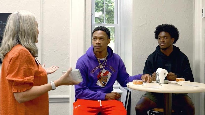 Students talking with director at table in the Clemmer-Long Center