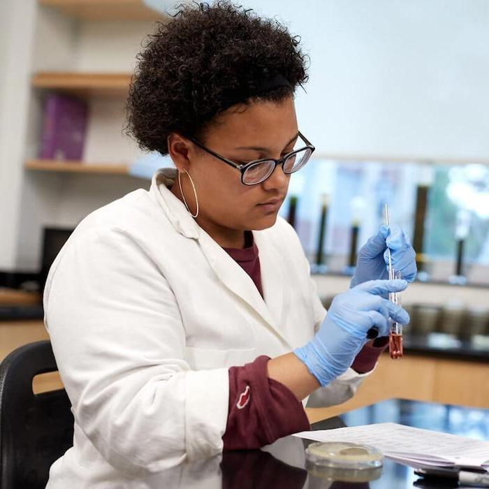 Student working with test tube in lab